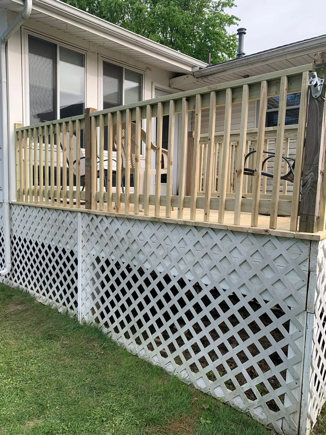 Elevated deck with railing and lattice skirting on a Central Illinois home