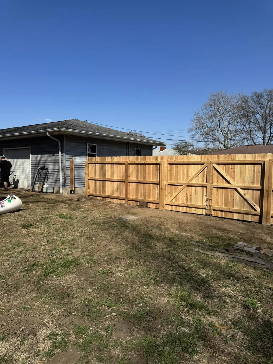 Solid wood privacy fence enclosing a backyard in Pekin, Illinois